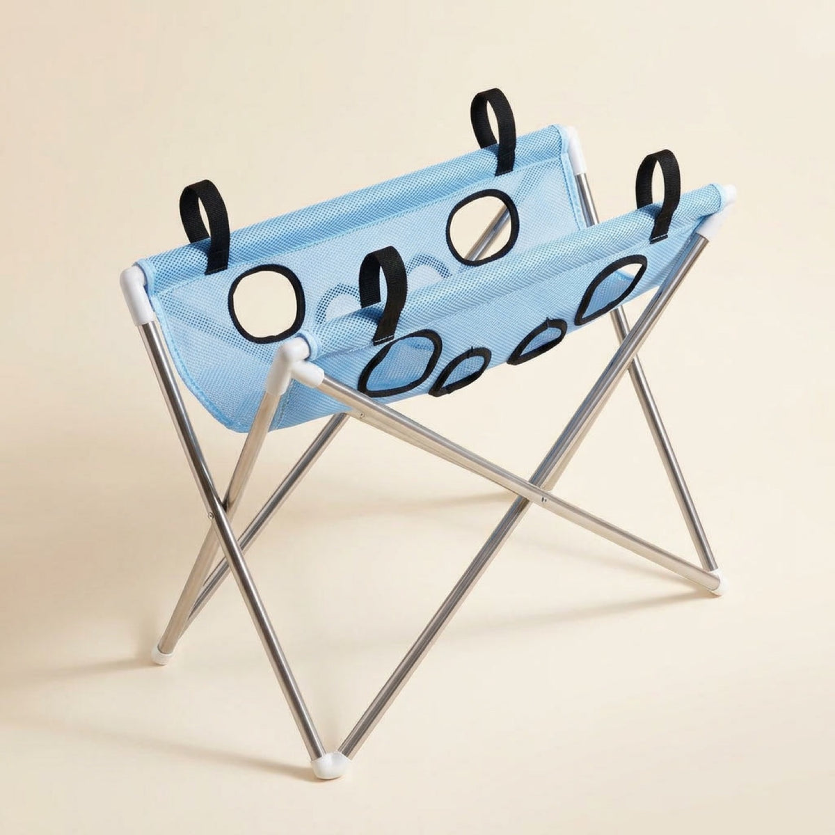 Pawperch pet washing and grooming stand in light blue, showing the eight black-rimmed leg holes and folding metal frame