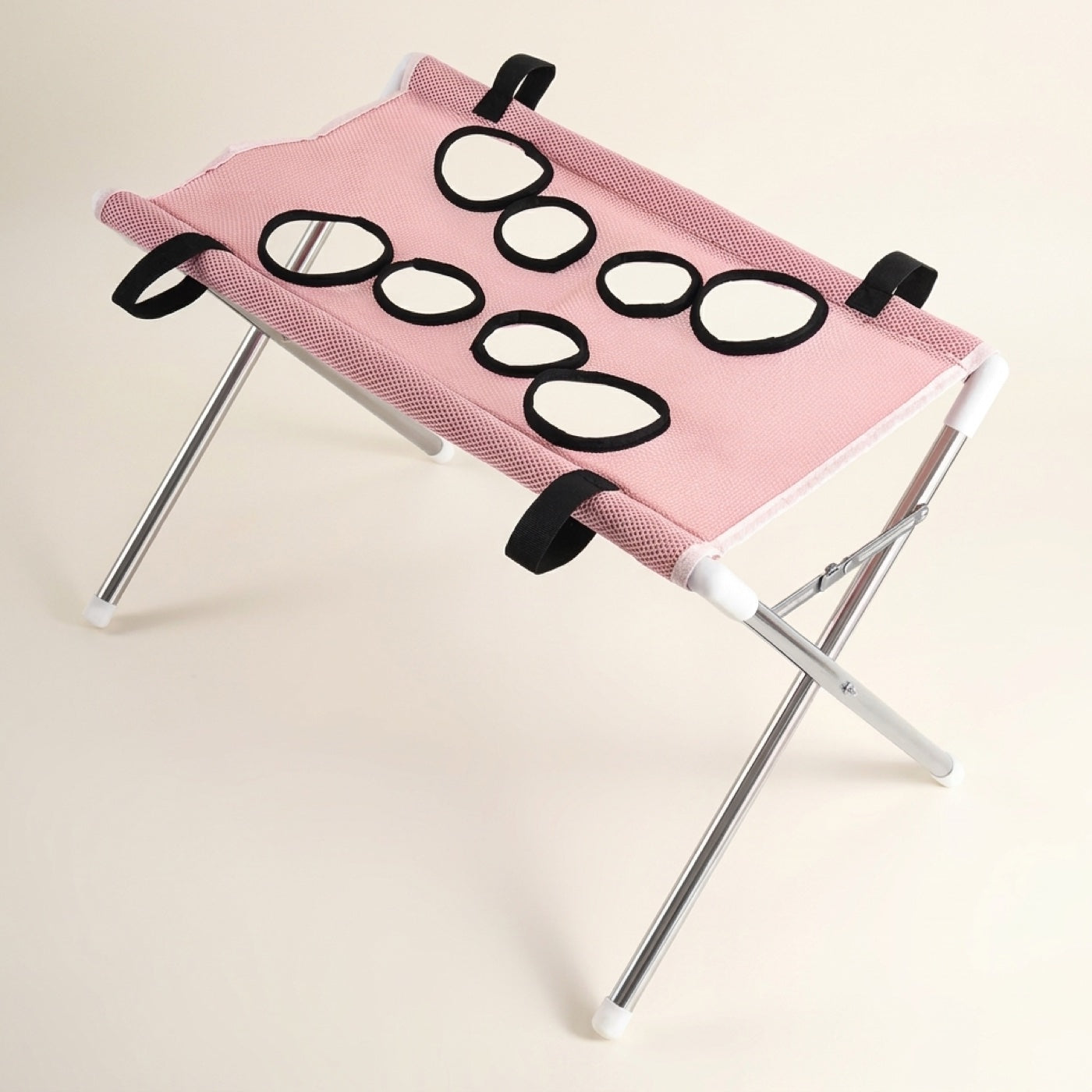 Pawperch pet washing and grooming stand in pink, showing the eight black-rimmed leg holes and folding metal frame